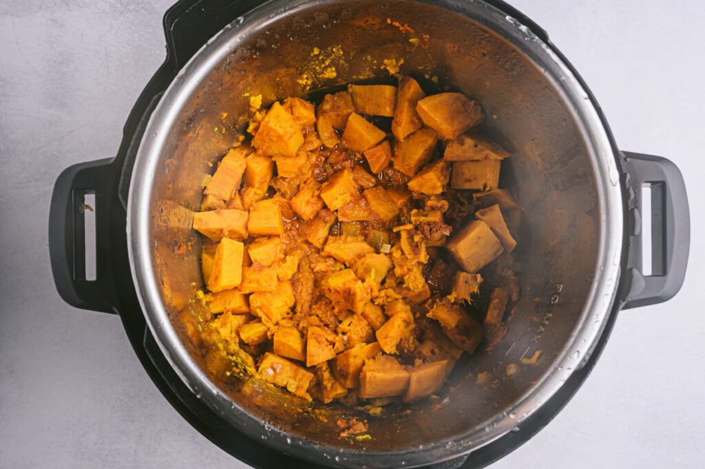 Add sweet potatoes, onion, garlic, coconut oil, turmeric, salt, ⅓ cup red curry paste, and ¾ cup water to your slow cooker. Stir and cook on low for 6-8 hours.