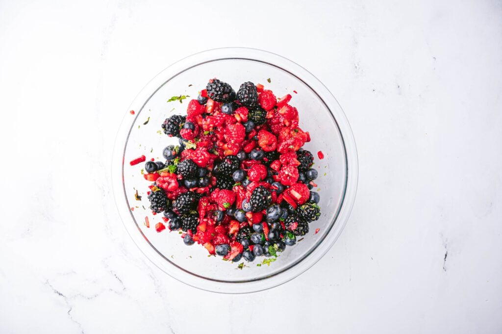 Microwave your honey for 5-10 seconds and pour it over your berries. Mix your berry salad until it’s coated with your honey lime dressing.