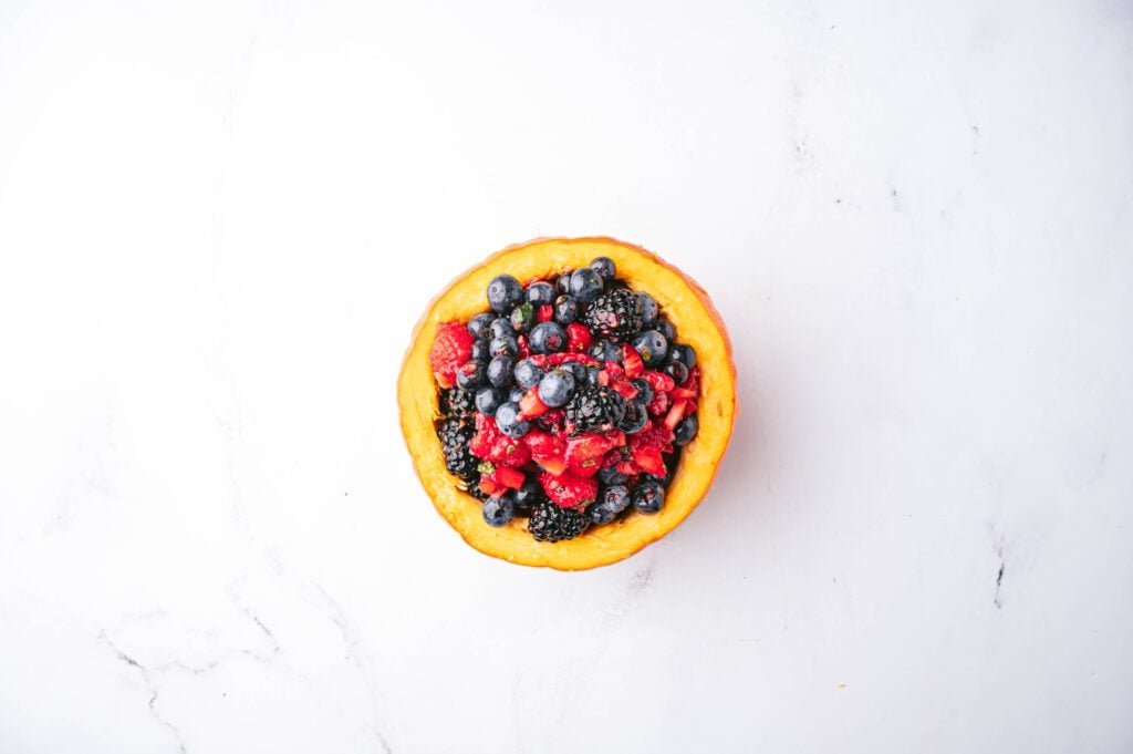 Scoop your berry fruit salad into your hollowed-out mini pumpkins and serve.