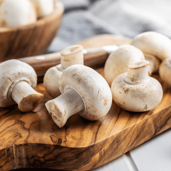 white mushrooms on cutting board