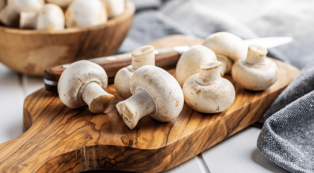 white mushrooms on cutting board