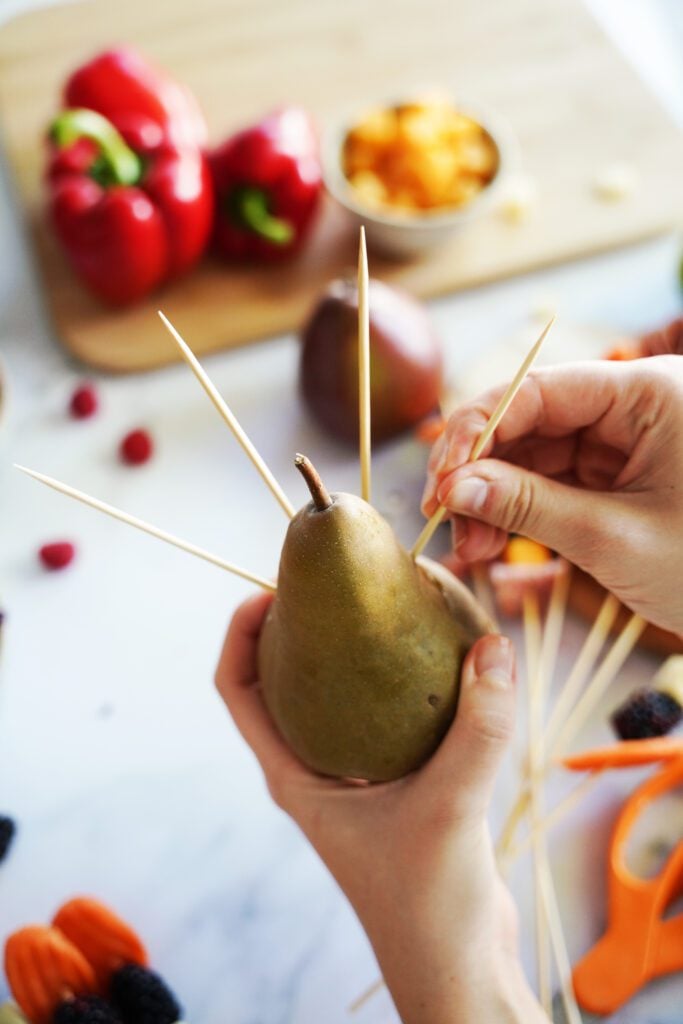 inserting skewers into pear