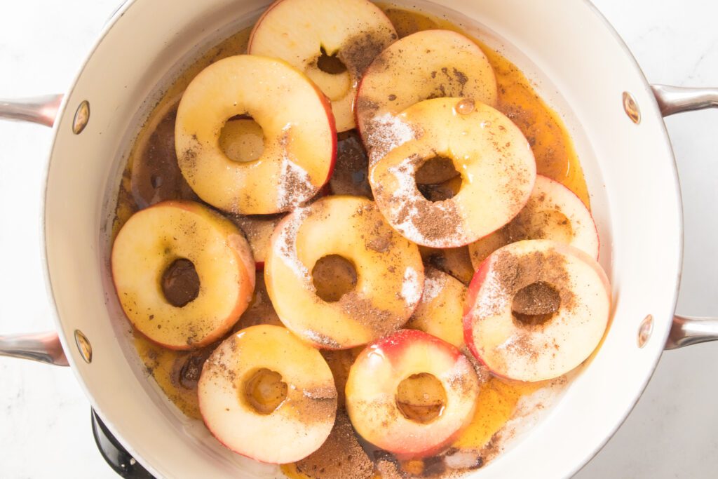 apple rings in skillet with coconut oil