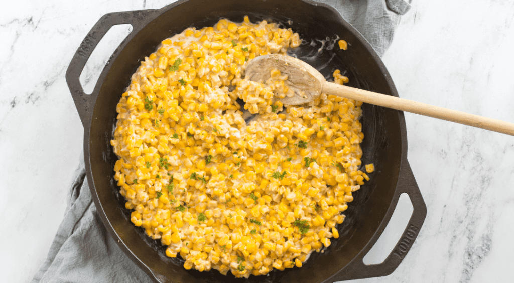 Honey Butter Skillet Corn with wooden spoon