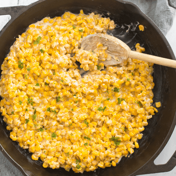 Honey Butter Skillet Corn with wooden spoon