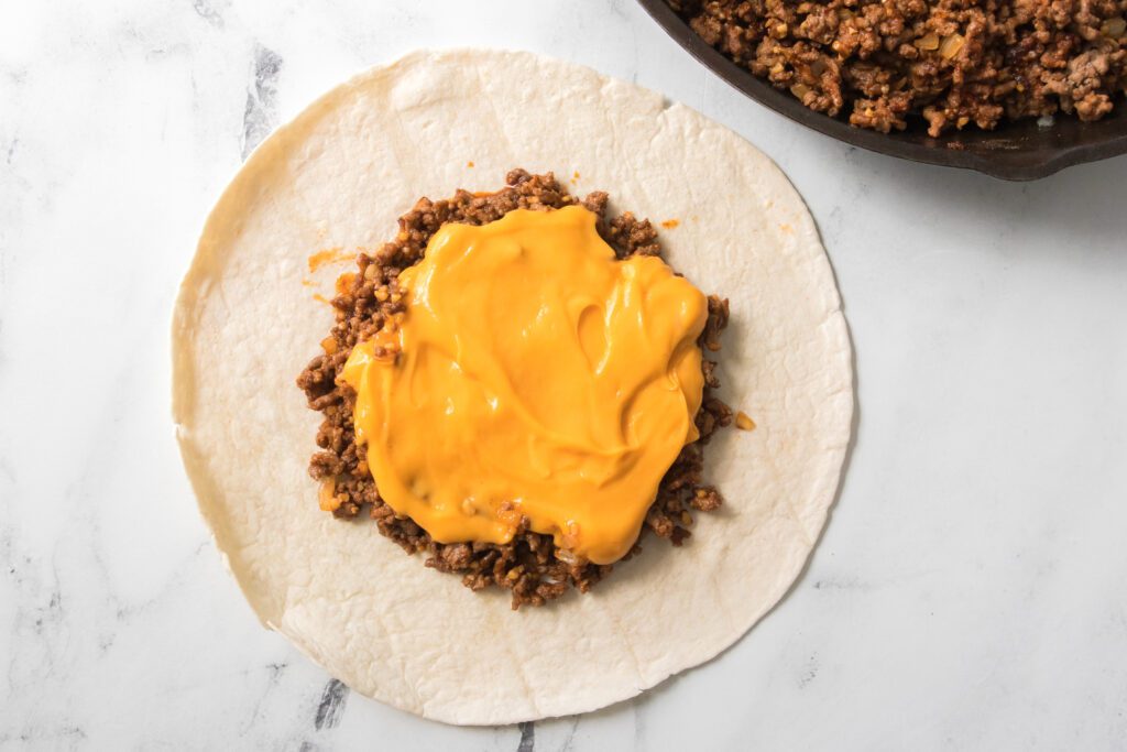 flour tortilla with ground beef and nacho cheese