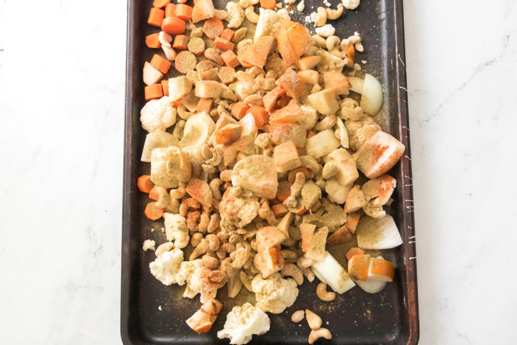 chopped veggies and pears on a baking sheet
