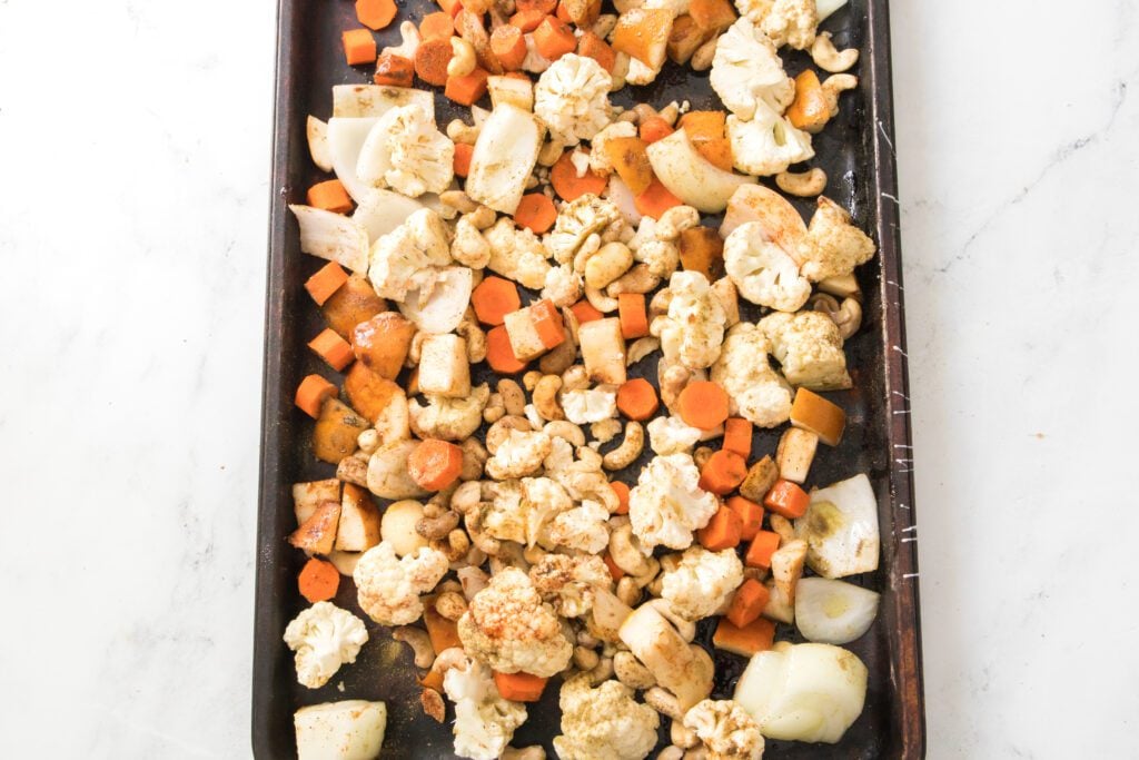 Vegetables and pears chopped on a baking sheet
