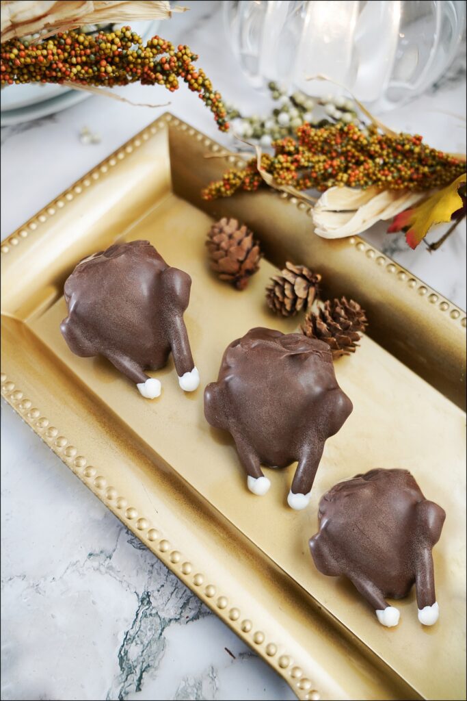 chocolate covered strawberry turkeys on a gold serving platter