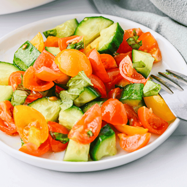 Cucumber and Tomato Salad on white plate