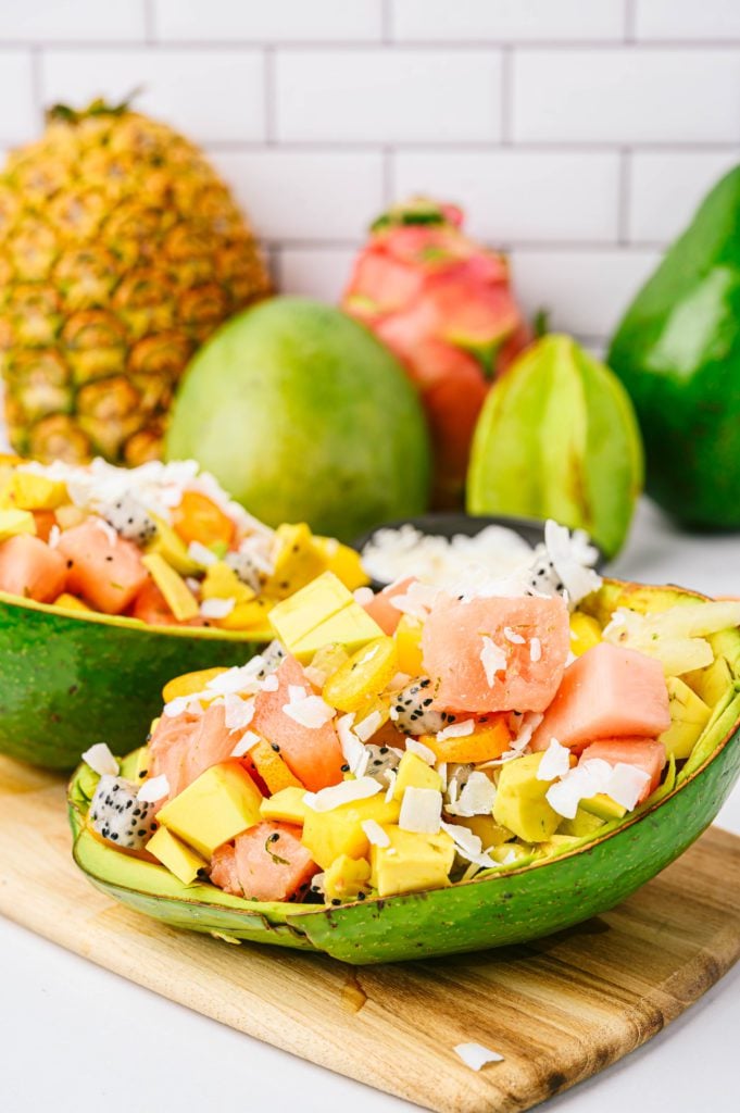 tropical fruit salad served in a tropical avocado skin with shredded coconut