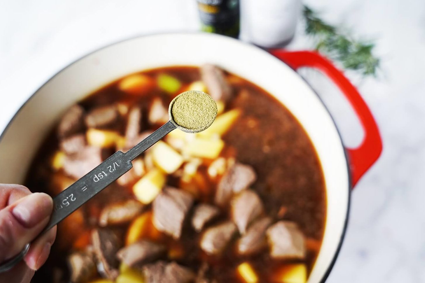 Beef Stew in Pot with measuring spoon of spices
