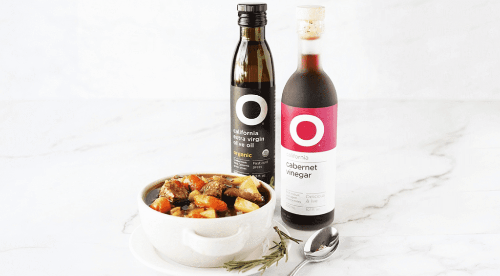 Beef Stew in dish with O Olive Oil Bottles