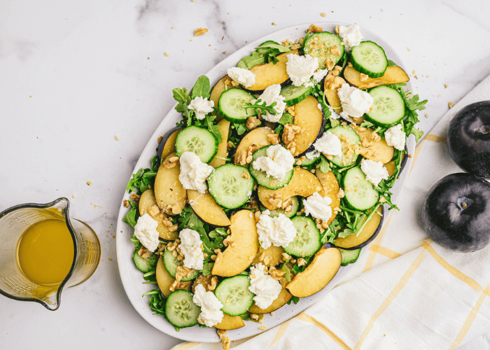 Overhead view of the Plumand Ricotta Salad with two whole plums