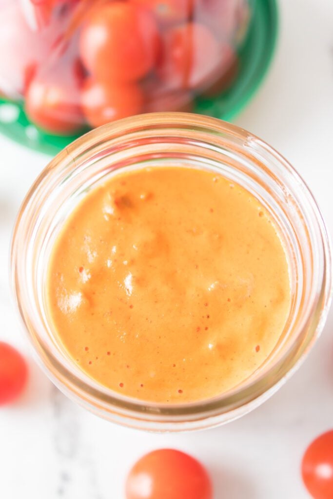 close up shot of tomato aioli in mason jar