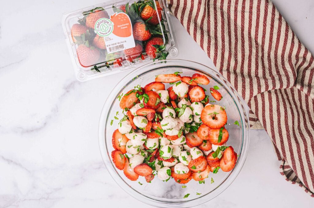 ingredients in bowl with Naturipe strawberries in the background