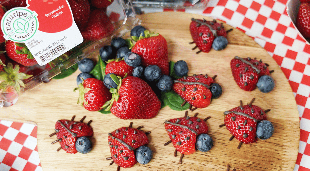 Strawberry Ladybugs on wood board on table