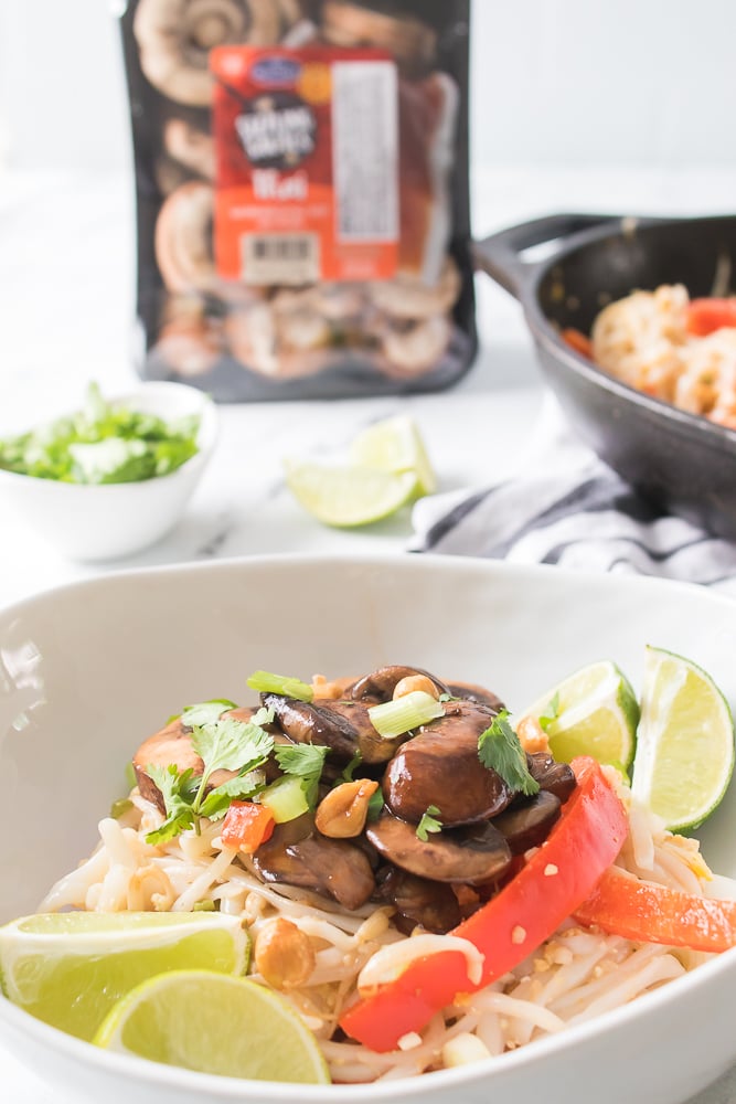 vertical head on shot of plated pad thai in white bowl