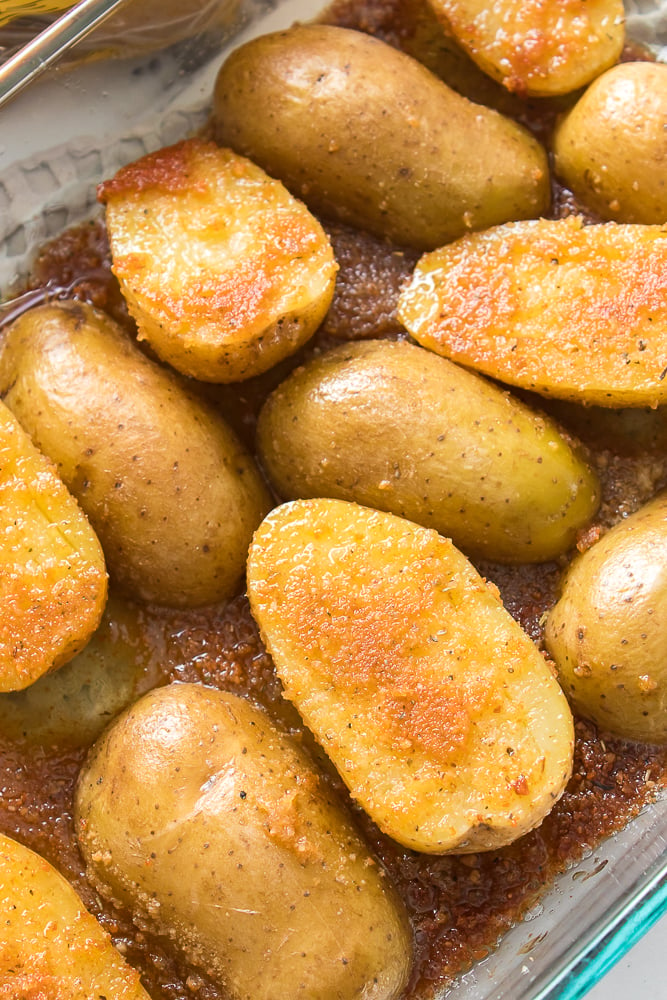 vertical close up shot of oven roasted potatoes some with skin up and down