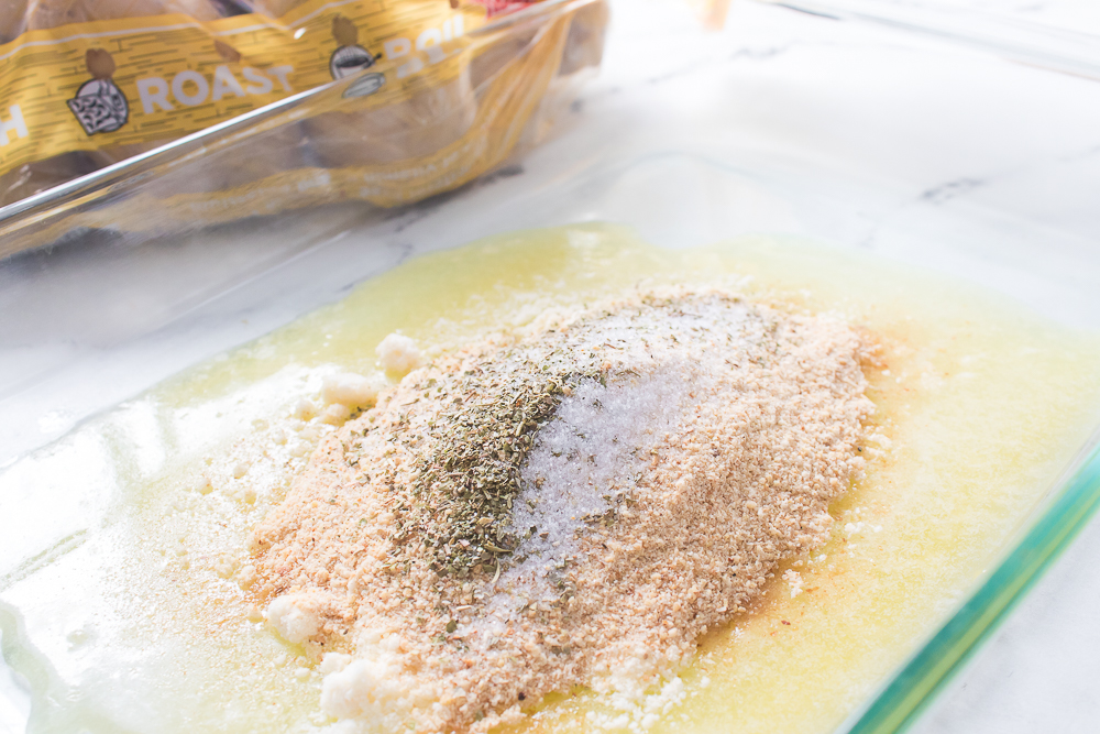 baking dish with melted butter and spices