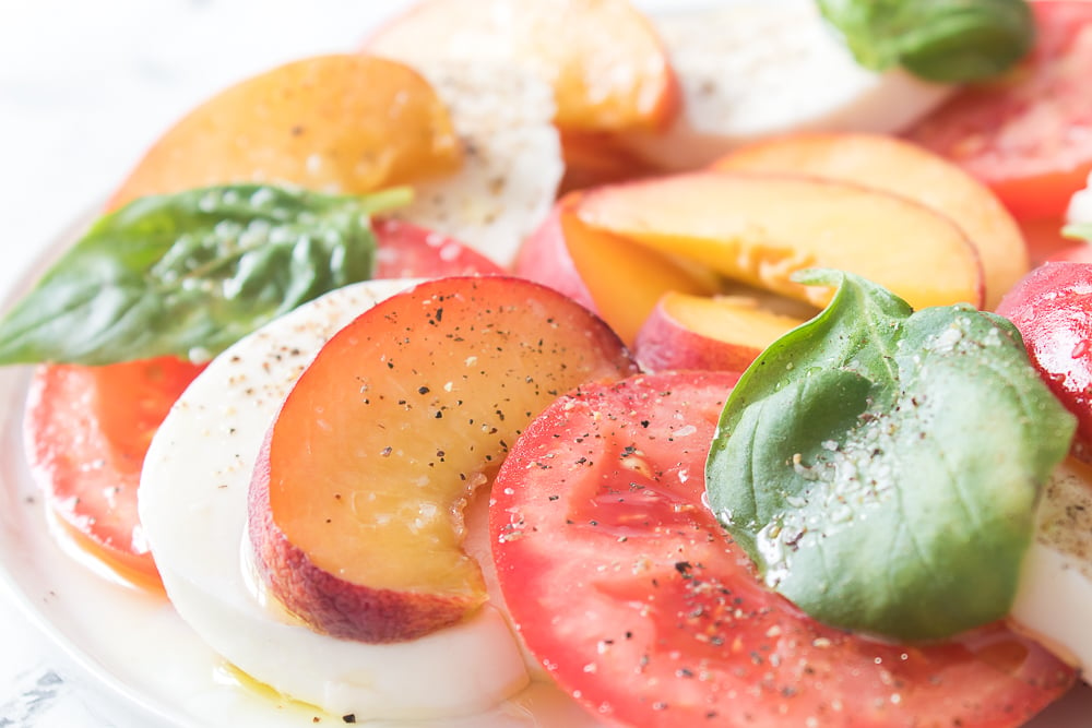 close up horizontal shot of peach caprese on plate