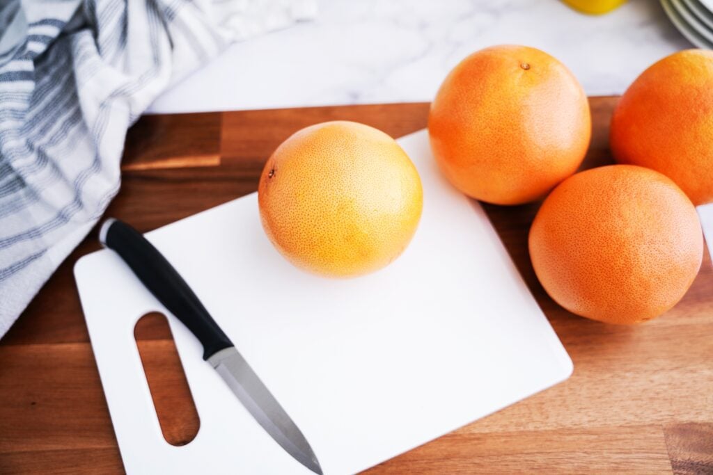 whole grapefruits on cutting board