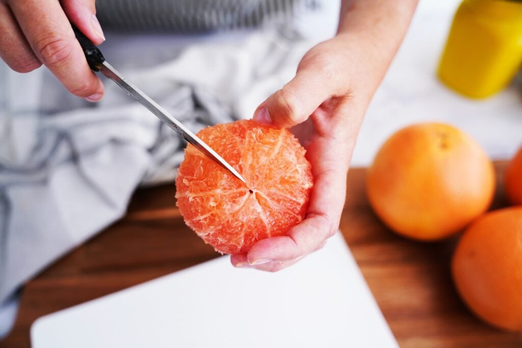cutting a segment of grapefruit