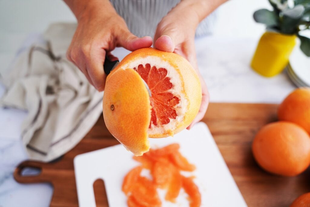 cutting into a grapefruit