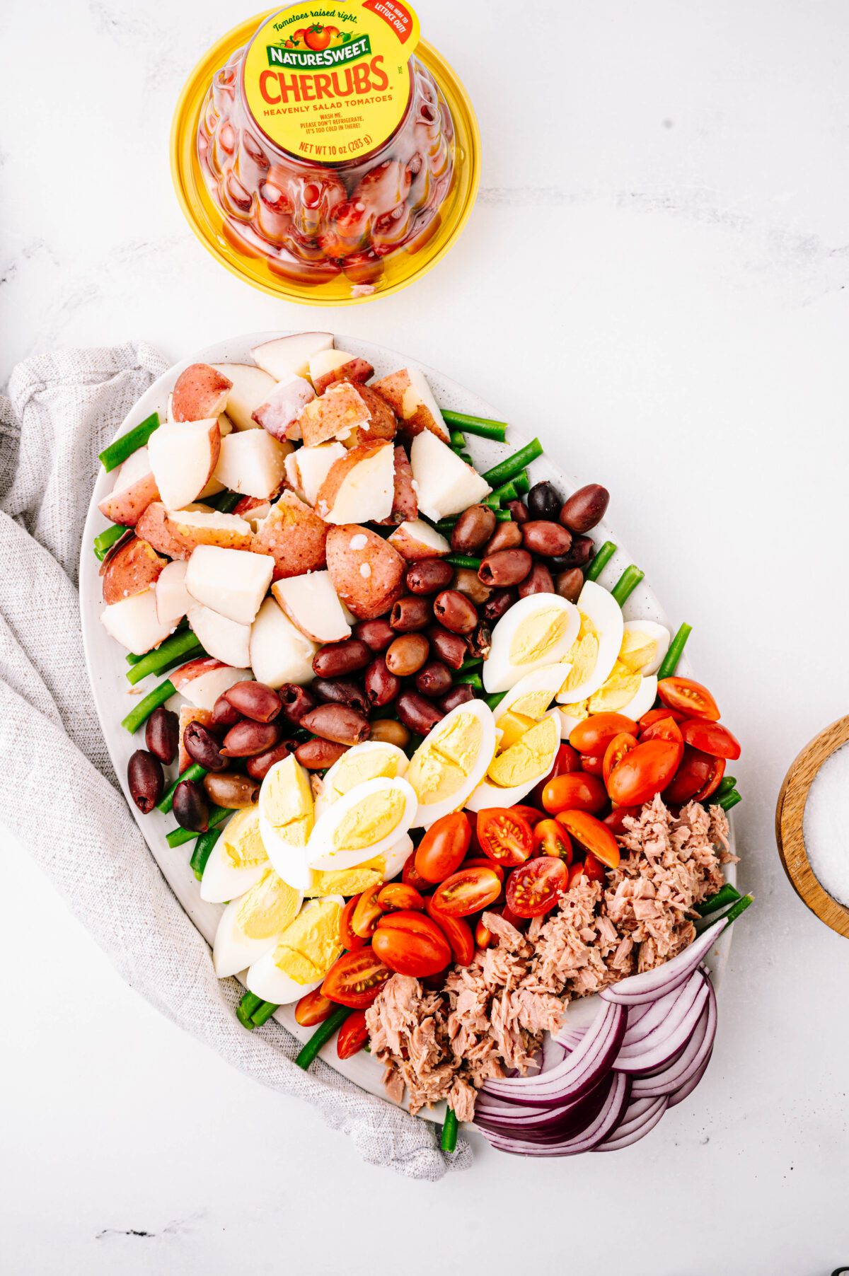 Vertical view of Nicoise salad with Cherubs® in background