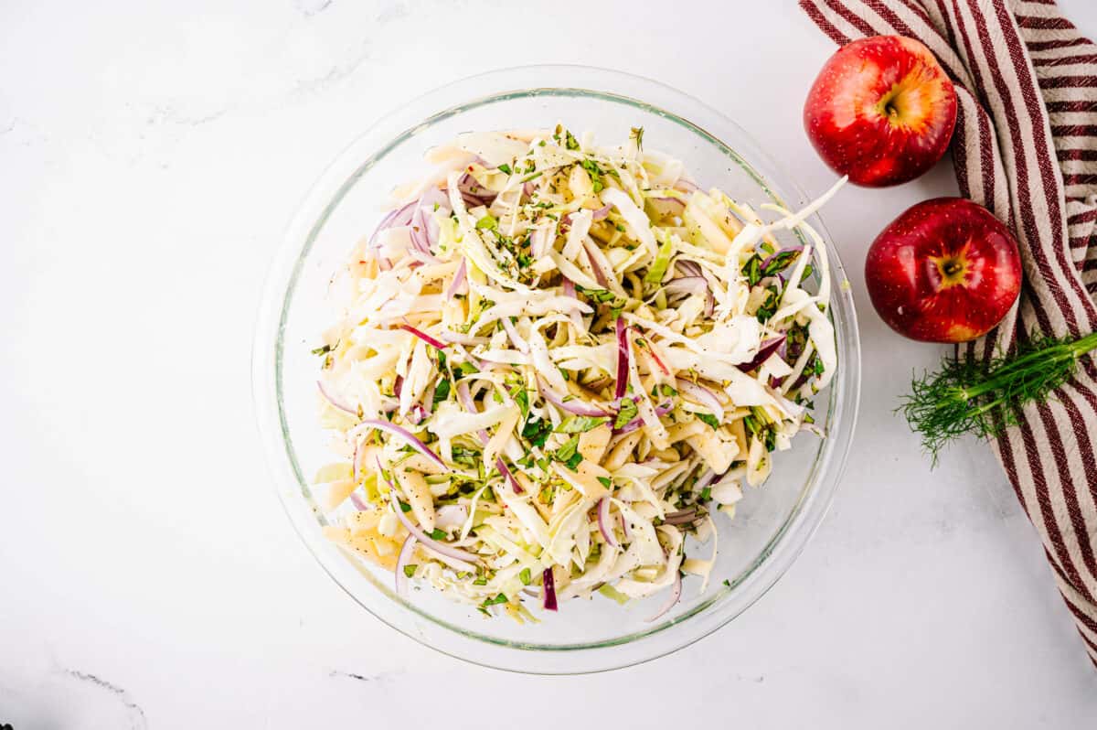 overhead shot of fennel salad with apples in glass bowl