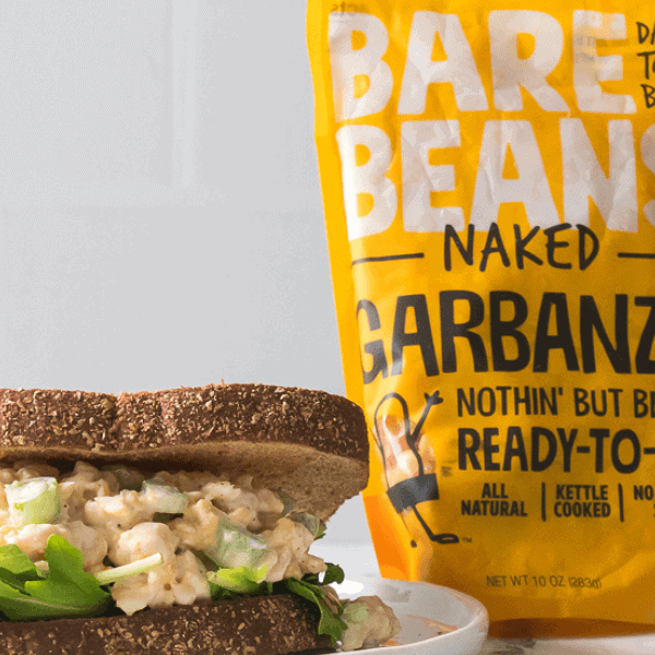 Chickpea Salad Sandwich on plate with Bare Beans package in background