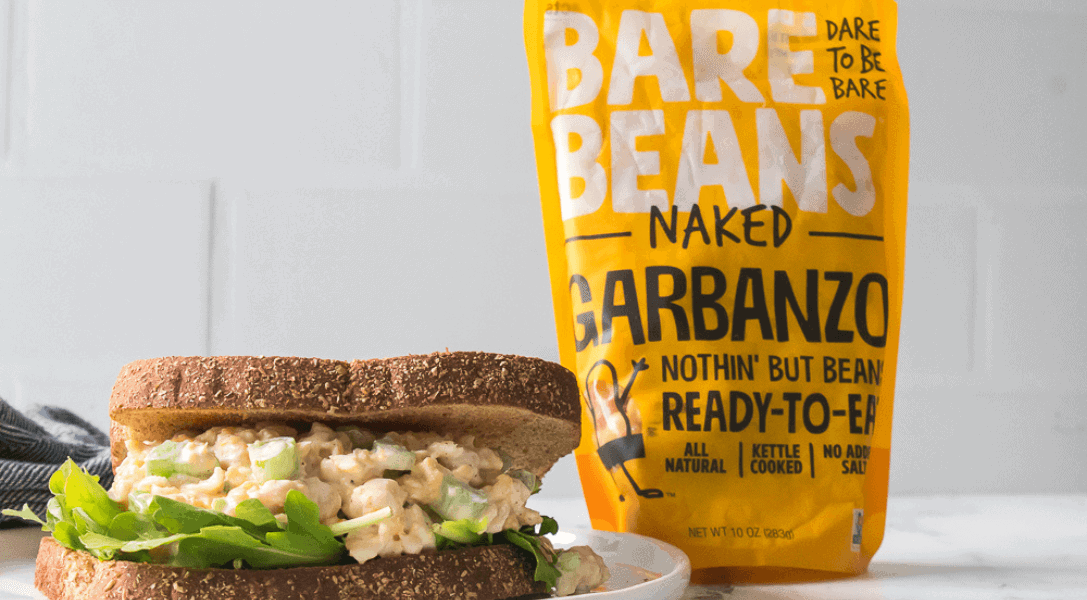 Chickpea Salad Sandwich on plate with Bare Beans package in background