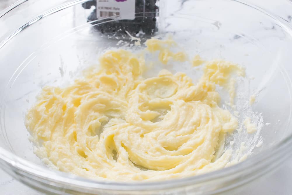 In a bowl, cream together the butter, granulated and powdered sugars until smooth and creamy.