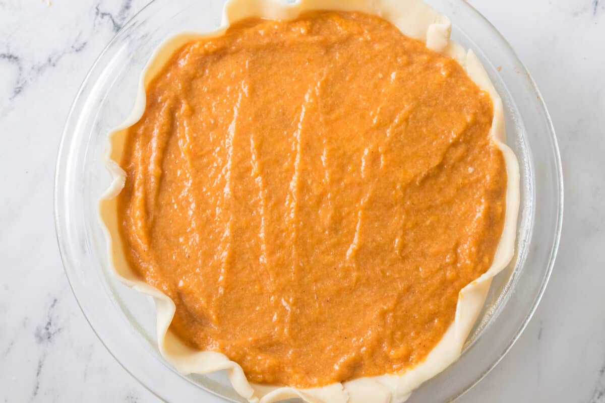 unbaked sweet potato and pie crust in pie dish