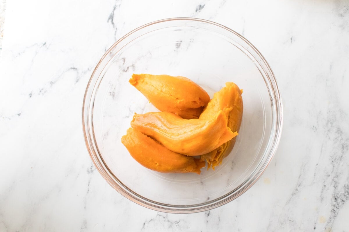 sweet potatoes that have been softened in a glass bowl