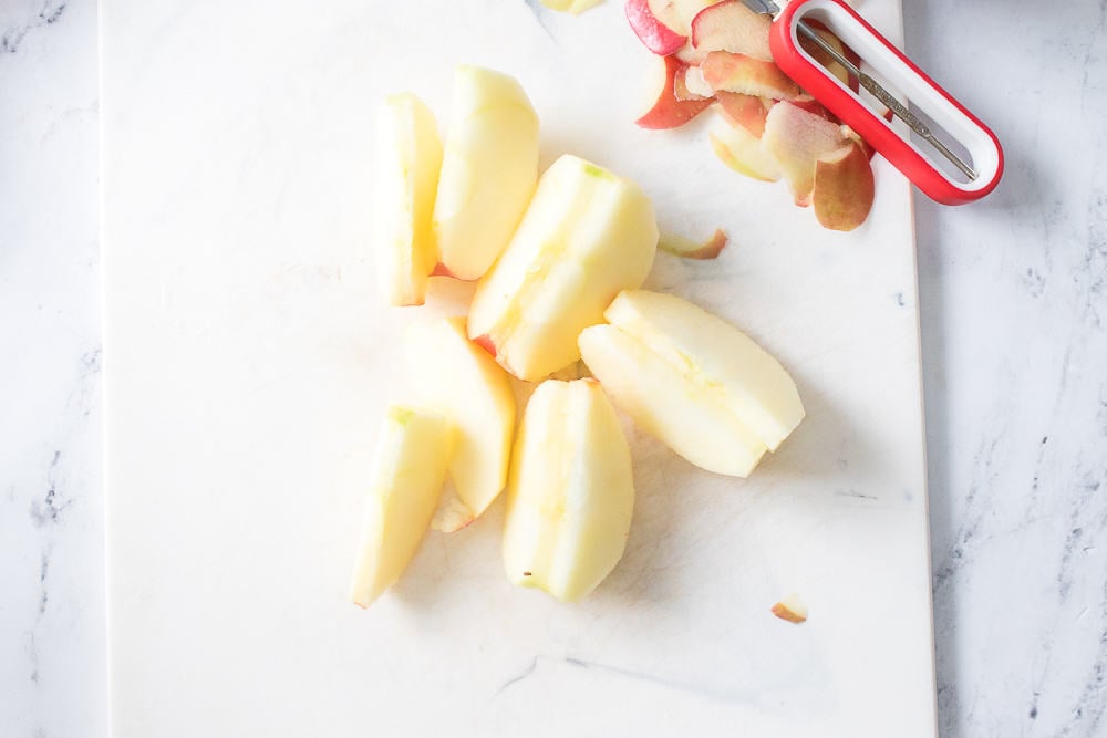 apple peeled and sliced on cutting board