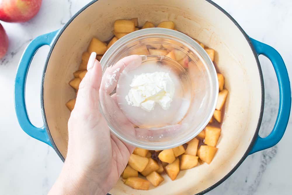 hand holding glass bowl with water and cornstarch