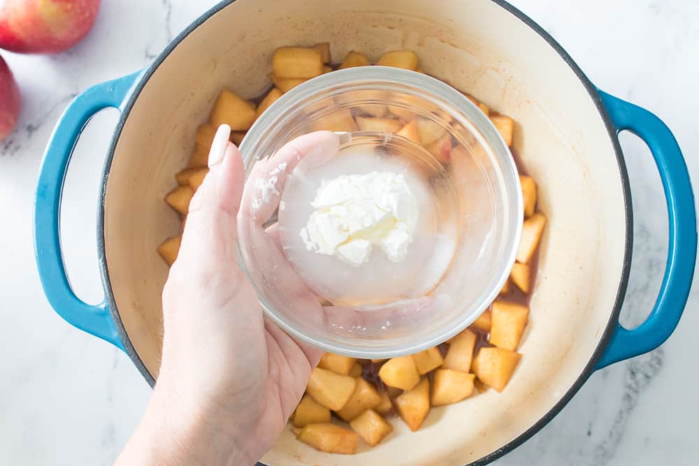 hand holding glass bowl with water and cornstarch