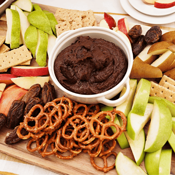 overhead view of Chocolate Hummus Dip on charcuterie board with apple and pear slices
