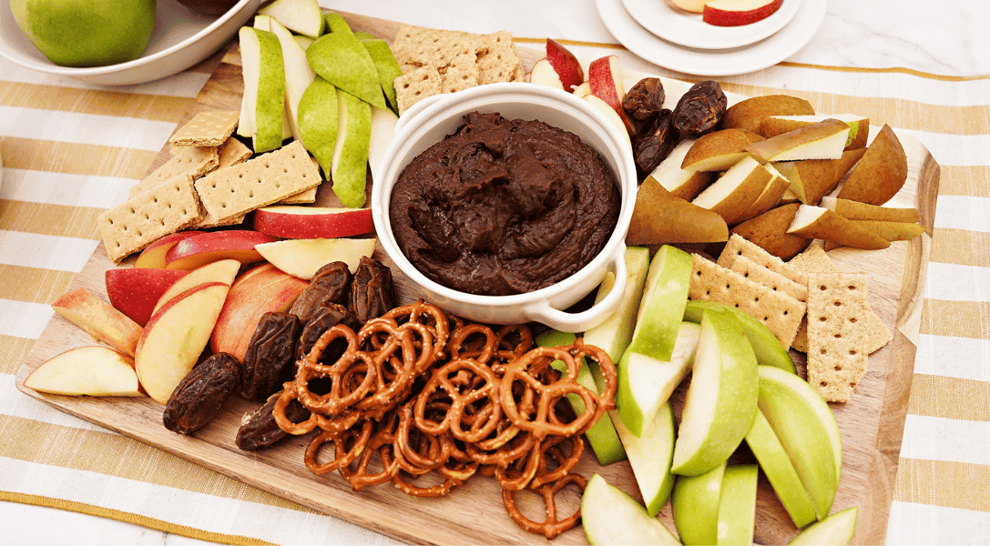 overhead view of Chocolate Hummus Dip on charcuterie board with apple and pear slices