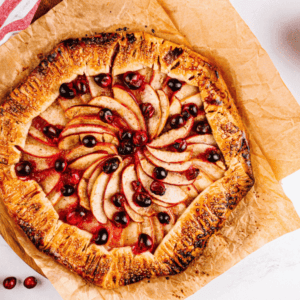 Overhead view of Cranberry Apple Galette with Envy™ apples and bowl of cranberries