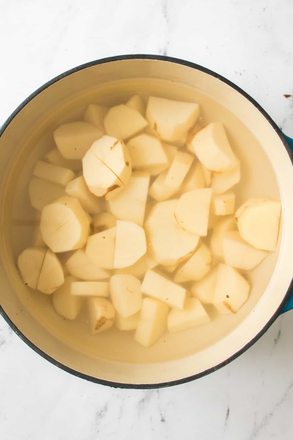 potatoes placed in pot with water