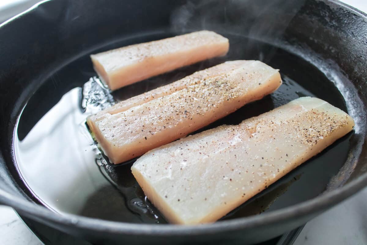 white fish in a cast iron skillet