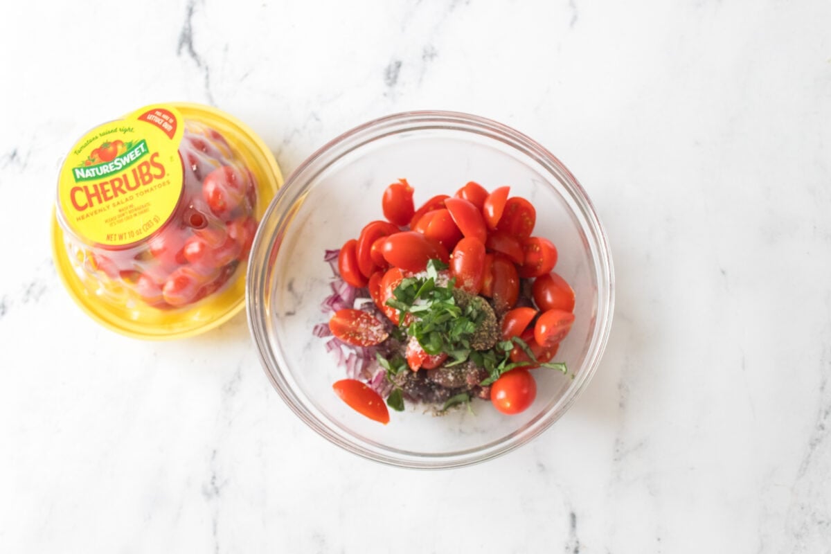 overhead shot of tapenade ingredients in glass bowl