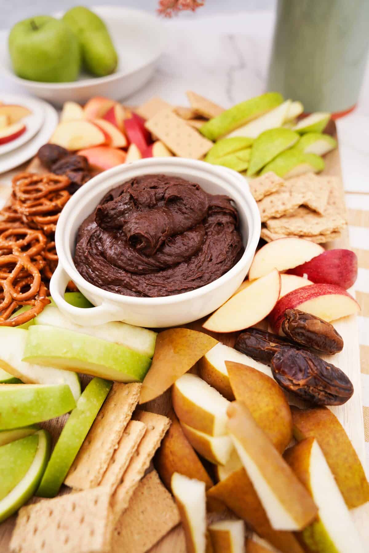 close up shot of chocolate hummus in a white serving dish