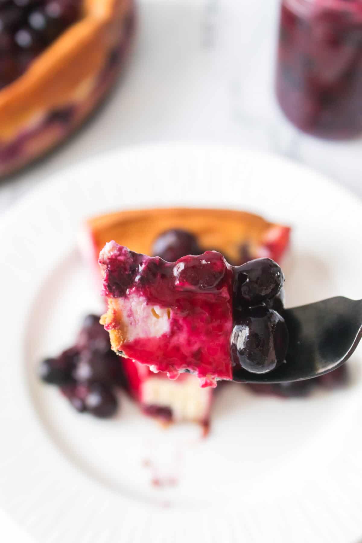 bite of blueberry cheesecake on fork