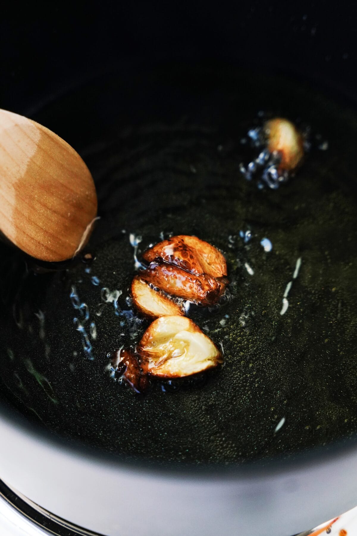 crushed garlic cooking in oil in saucepan