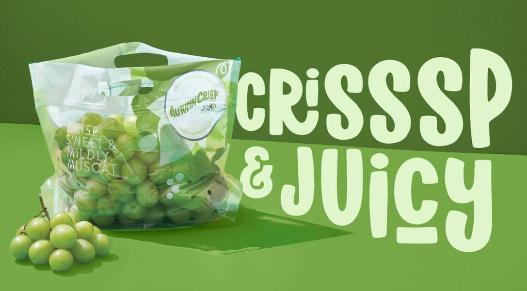 AUTUMNCRISP® grapes in package with green background and Crisp & Juicy