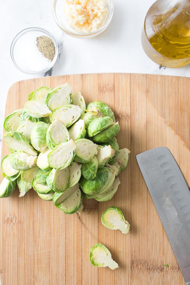 brussel sprouts cut in half on cutting board