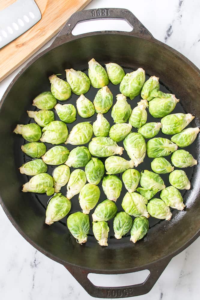 brussel sprouts placed face down in cast iron skillet